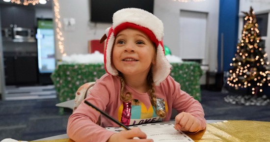 Cutline: A child prepares a letter for Santa at NPCC’s Santa’s Workshop last year. This year’s event is scheduled for Dec. 3.